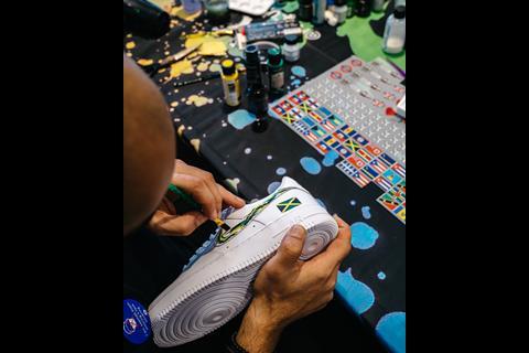 Close-up of someone customising their trainers with paints at Foot Locker Brixton